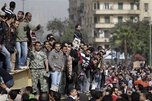 Egyptian anti-government protesters climb atop an Egyptian army armored personnel carrier in Cairo, Egypt, Saturday, Jan. 29, 2011. (AP Photo/Ben Curtis) (AP)