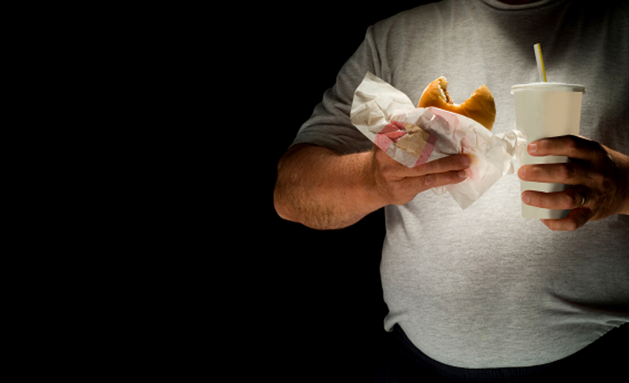 Digital Capture, man eating hamburger with soda. (Brian Toro)