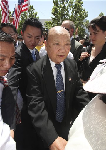 FILE - In this May 11, 2009 file photo, Former Laotian General Vang Pao, center, is escorted by supporters to the federal courthouse, in Sacramento, Calif.  Pao, a former general in the Royal Army of Laos who led thousands of Hmong mercenaries in a CIA backed secret army during the Vietnam War, has died. He was 81.  Pao died Thursday, Jan. 6, 2011, after being hospitalized for about 10 days, said Michelle Von Tersch, a spokeswoman for Clovis Community Medical Center. (AP Photo/Rich Pedroncelli, File) (AP)