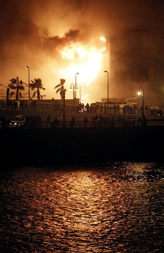 Fires burn in the National Democratic Party ruling party headquarters, after it was set alight by anti-government protesters, in downtown Cairo, Egypt, Friday, Jan. 28, 2011. (AP Photo/Ben Curtis) (AP)