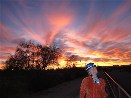 In this Dec. 18, 2010 image, Rep. Gabrielle Giffords laughs while taking a break during a bike ride in Tucson, Ariz. The cycling community has come out in force with weekly vigil rides in honor of Giffords and the other victims of a Jan. 8 shooting outside a grocery store during a political event. (AP Photo/Courtesy of Raoul Erickson) (AP)