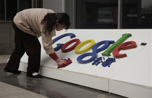 In this photo taken Monday, March 22, 2010, a Chinese woman cleans the Google logo outside the Google China headquarters in Beijing, China.  A leaked U.S. government cable shows sources told American diplomats that hacking attacks against Google were ordered by China's top ruling body.  (AP Photo/Ng Han Guan) (AP)