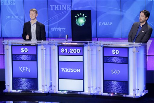 "Jeopardy!" champions Ken Jennings, left, and Brad Rutter, right, look on as an IBM computer called "Watson" beats them to the buzzer to answer a question during a practice round of the "Jeopardy!" quiz show in Yorktown Heights, N.Y., Thursday, Jan. 13, 2011. It's the size of 10 refrigerators, and it swallows encyclopedias whole, but an IBM computer was lacking one thing it needed to battle the greatest champions from the "Jeopardy!" quiz TV show - it couldn't hit a buzzer. But that's been fixed, and on Thursday the hardware and software system named Watson played a competitive practice round against two champions. A "Jeopardy!" show featuring the computer will air in mid-February, 2011. (AP Photo/Seth Wenig) (AP)