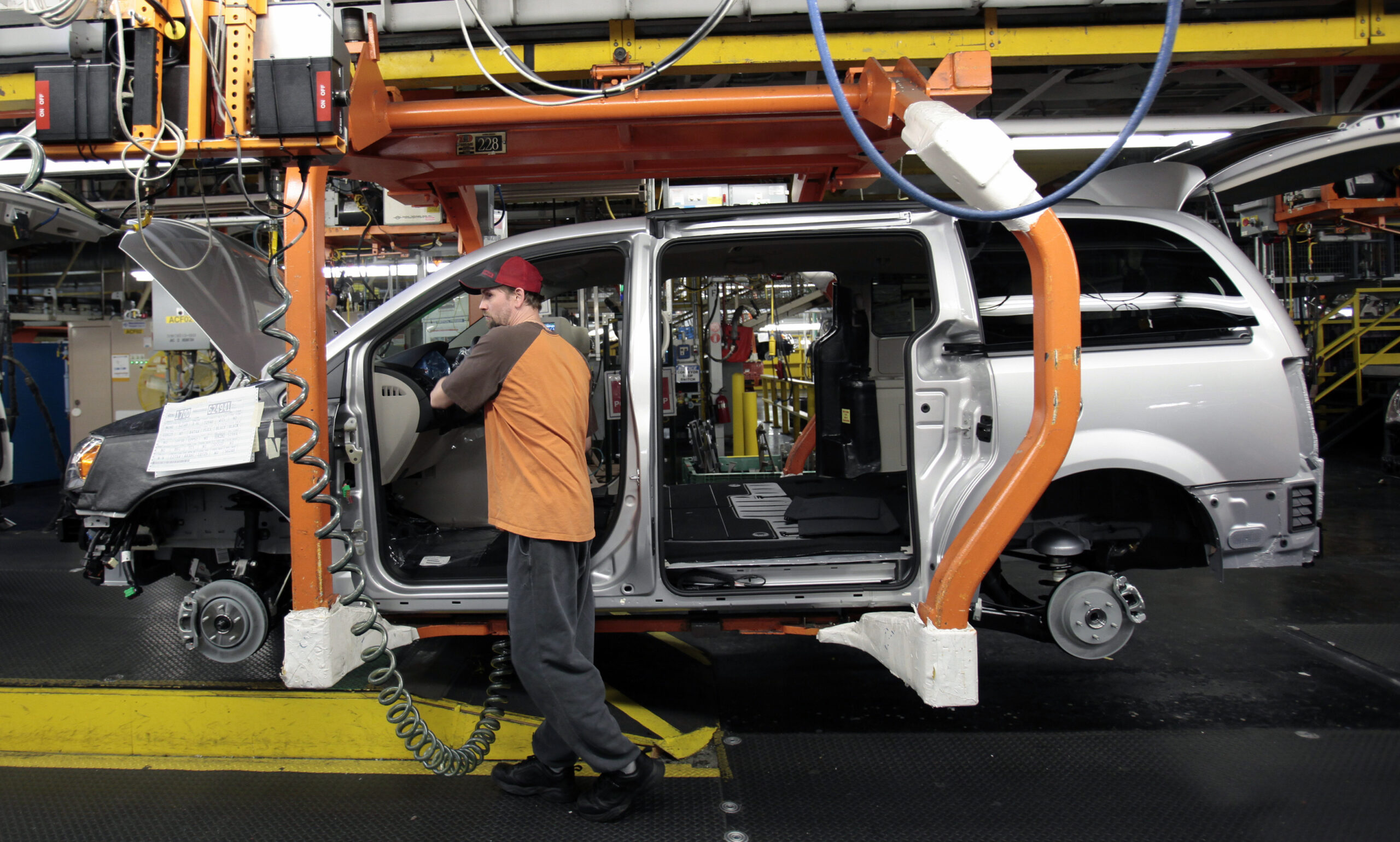 A Chrysler auto worker is seen working on a partially assembled Chrysler minivan on the assembly line during the production launch of the new 2011 Dodge Grand Caravan's and Chrysler Town & Country minivans at the Windsor Assembly Plant in Windsor, Ontario January 18, 2011. Chrysler Group Chief Executive Sergio Marchionne vowed to keep the automaker on top of the minivan segment in the North American market and said the company will develop a new type of minivan by 2014. REUTERS/Rebecca Cook  (CANADA - Tags: TRANSPORT EMPLOYMENT BUSINESS) (Reuters)