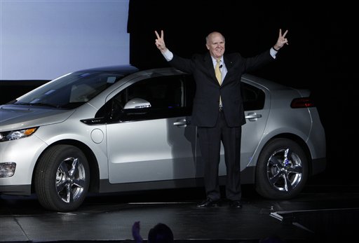 General Motors chief executive officer Dan Akerson raises his arms next to the Chevrolet Volt with the first vehicle identification number at the General Motors Hamtramck assembly plant in Hamtramck, Mich., Tuesday, Nov. 30, 2010. (AP Photo/Paul Sancya) (AP)