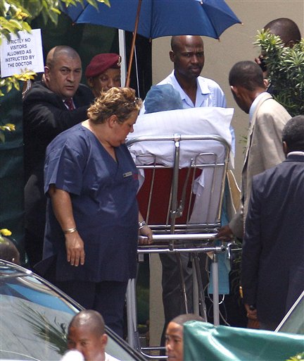 Former South African  President Nelson Mandela is wheeled out on a stretcher, as he leaves the Milpark Hospital in Johannesburg, South Africa, Friday, Jan. 28, 2011. Mandela was discharged to begin home-based care, after spending two-and-a-half days in hospital for treatment for a respiratory infection. (AP Photo/Themba Hadebe) (AP)