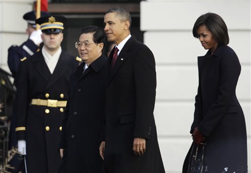 President Barack Obama and first lady Michelle Obama welcome China's President Hu Jintao during a state arrival on the South Lawn of the White House in Washington, Wednesday, Jan. 19, 2011. (AP Photo/Charles Dharapak) (AP)