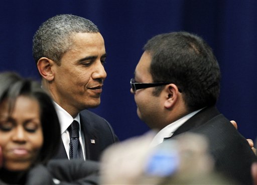 President Barack Obama hugs Daniel Hernandez, an intern for Rep. Gabrielle Giffords at a memorial service for the victims of Saturday's shootings at McKale Center on the University of Arizona campus Wednesday, Jan. 12, 2011, in Tucson, Ariz. (AP Photo/Chris Carlson) (AP)