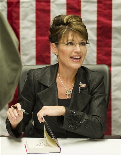 FILE - In a Nov. 30, 2010 file photo, Sarah Palin signs copies of her new book, "America By Heart," in Little Rock, Ark. Palin has posted a nearly eight-minute video on her Facebook page condemning those who blame political rhetoric for the Arizona shooting that gravely wounded U.S. Rep. Gabrielle Giffords.  In the video posted Wednesday, Dec. 12, 2010, the 2008 GOP vice presidential candidate said vigorous debates are a cherished tradition. But she said after the election, both sides find common ground, even though they disagree.  (AP Photo/Brian Chilson, File) (AP)