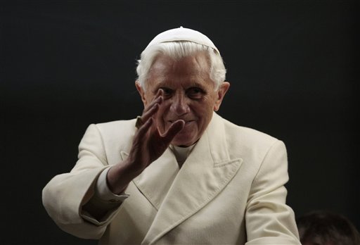 Pope Benedict XVI blesses the faithful as he arrives in St. Peter's square to bless the nativity scene at the Vatican, Friday, Dec. 31, 2010. Pope Benedict XVI marked the final hours of 2010 on Friday with public prayer and a word of concern for families struggling with economic troubles. Benedict gave thanks for God's grace and love throughout the year as he presided over a traditional New Year's Eve vespers service in St. Peter's Basilica. (AP Photo/Gregorio Borgia) (AP)