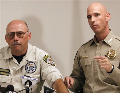 File - This Oct. 7, 2010 file photo shows Pinal County Sheriff's Deputy Louie Puroll, left, during a news conference as Pinal County Sheriff Paul Babeu answers a question, at the Pinal County Sheriff's complex, in Florence, Ariz.  Arizona officials on Monday, Jan. 3, 2011, reopened the investigation into a deputy's explanation of how he was shot in the remote desert south of Phoenix amid speculation it was a hoax timed to enflame the debate over illegal immigration. The Pinal County Sheriff's Office announced its decision Monday after two nationally known forensic pathologists raised questions. (AP Photo/Ross D. Franklin) (AP)