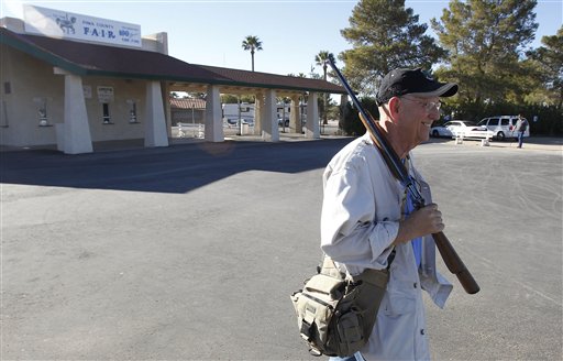 Alex Doster, of Tucson, Ariz., leaves with his purchase at the Crossroads of The West Gun Shows gun show at the Pima County Fairgrounds Saturday, Jan. 15, 2011, in Tucson, Ariz.  The gun show went off as planned to about 4,000 attendees on the first day, a week after a violent mass shooting happened in Tucson where 19 victims were shot, including Rep. Gabrielle Giffords, D-Ariz., who is still in critical condition, and the shooting left six of those dead. (AP Photo/Ross D. Franklin) (AP)