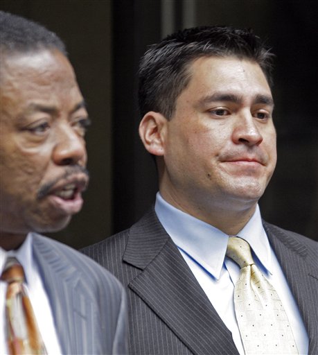 Security guard Alberto Alvarez, right, listens as his attorney Carl Douglas talks to reporters as they leave the preliminary hearing for Michael Jackson's doctor Conrad Murray who is charged in the death of the singer, at Los Angeles Superior Court, Wednesday, Jan. 5, 2011.  (AP Photo/Reed Saxon) (AP)