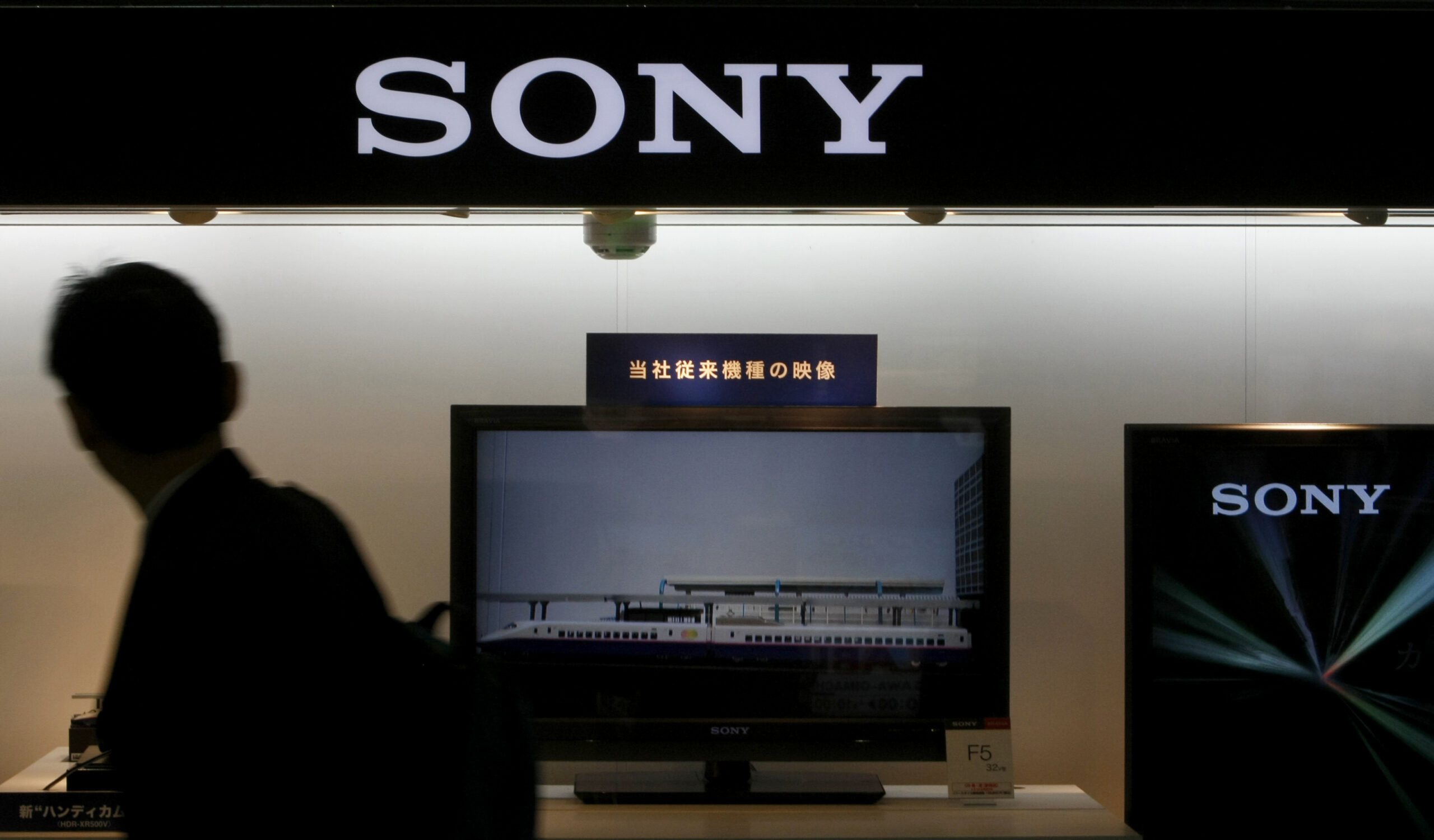 A man walks past a display of Sony's products near its headquarters in Tokyo May 14, 2009. Sony Corp promised on Thursday to halve this year's losses, but the electronics to entertainment giant's better-than-expected outlook offered little solace to markets vexed by glum U.S. retail sales.   REUTERS/Kim Kyung-Hoon (JAPAN BUSINESS) (Reuters)