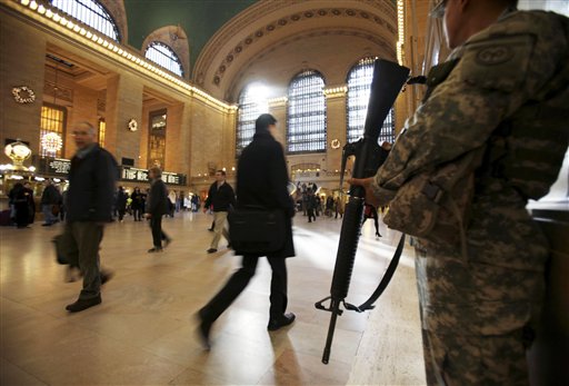 FILE - In this Nov. 24, 2010 file photo, National Guard security personnel watch as travelers make their way through Grand Central Station in New York. As the holiday tourist season begins in the Big Apple, there are reminders everywhere of how being the countrys main target for terrorism has gradually changed this city. (AP Photo/Seth Wenig, File) (AP)
