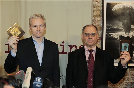 WikiLeaks founder Julian Assange, left, accompanied by former Swiss banker Rudolf Elmer, right, are seen after Elmer handed Assange two CD cases full of files, following a news conference at the Frontline Club in London, Monday Jan. 17, 2011. Elmer blew the whistle on the conduct of Julius Baer Bank in the Cayman Islands for which he is set to stand trial in Zurich, Switzerland, on Jan. 19 for breaching Swiss bank secrecy laws. Accompanied by his lawyer Jack Blum, he will reveal more details of alleged abuses in the world of offshore financial centres. As he did back in 2007 he will pass the said documents and information to Wikileaks. (AP Photo/Lefteris Pitarakis) (AP)