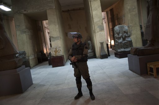 A member of the Egyptian special forces stands guard on the main floor of the Egyptian Museum in Cairo, Egypt, Thursday, Feb. 10, 2011. Would-be looters broke into Cairo's famed Egyptian Museum on Saturday, Jan. 29, ripping the heads off two mummies and damaging about 75 small artifacts before being caught and detained by army soldiers. (AP Photo/Emilio Morenatti) (AP)
