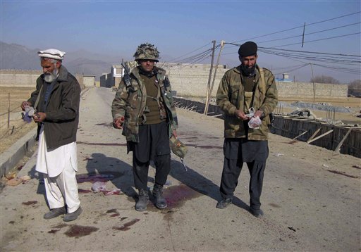 Pakistani paramilitary soldiers survey the site of suicide bombing in Khar, the main town of Pakistan's Bajur tribal region, along theAfghan border, Saturday, Dec. 25, 2010. A female suicide bomber detonated her explosives-laden vest killing scores of people at an aid distribution center in northwestern Pakistan while army helicopter gunships and artillery killed a similar number of Islamic militants in neighboring tribal regions near the Afghan border, officials said. (AP Photo/Anwarullah Khan) (AP)
