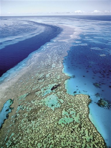 FILE - In this Sept. 2001 file photo provided by Queensland Tourism, the Great Barrier Reef off Australia's Queensland state is shown in an aerial view. Researchers said it is too early to know exactly how much of the reef has been affected by recent flooding, which carved a wide path of destruction on land before draining into the sea off the country's northeast coast. (AP Photo/Queensland Tourism, File)  EDITORIAL USE ONLY (AP)