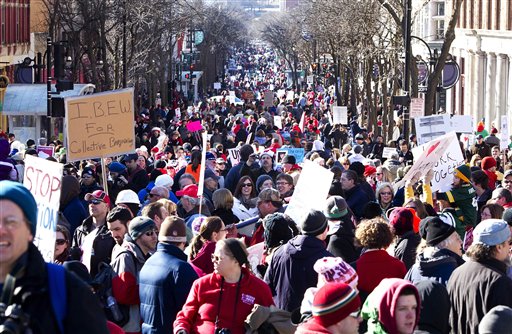 Supporters of Wisconsin Governor Scott Walker demonstrate  during a rally outside  the Wisconsin State Capitol  on  Saturday, Feb.  19, 2011 in Madison.   A few dozen police officers stood between supporters of GOP Gov. Scott Walker on the muddy east lawn of the Capitol and the much larger group of pro-labor demonstrators who surrounded them. The protest was peaceful as both sides exchanged chants of Pass the bill! Pass the bill! and Kill the bill! Kill the bill! (AP Photo/Wisconsin State Journal, Steve Apps) (AP)
