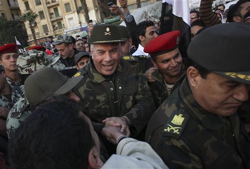 Unidentified  Egyptian army major generals greet people as they walk through Tahrir Square in Cairo, Egypt, Saturday, Feb. 12, 2011. Egypt exploded with joy, tears, and relief after pro-democracy protesters brought down President Hosni Mubarak on Friday with a momentous march on his palaces and state TV. The ruling military pledged Saturday to eventually hand power to an elected civilian government and reassured allies that Egypt will abide by its peace treaty with Israel. (AP Photo/Tara Todras-Whitehill) (AP)
