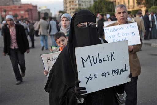 A woman carrying a placard referring to Egyptian President Hosni Mubarak attends a demonstration by anti-government protesters in Cairo's Tahrir Square, Egypt, Monday, Jan. 31, 2011. A coalition of opposition groups called for a million people to take to Cairo's streets Tuesday to demand the removal of Mubarak. AP Photo/Lefteris Pitarakis) (AP)