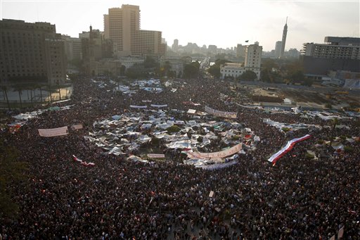 Anti-government protesters demonstrate in Tahrir Square, in Cairo, Egypt, Tuesday, Feb. 8, 2011. Protesters appear to have settled in for a long standoff, turning Tahrir Square into a makeshift village with tens of thousands coming every day, with some sleeping in tents made of blankets and plastic sheeting. The arabic on the sign reads "The rage brings the light of freedom". (AP Photo/Tara Todras-Whitehill) (AP)
