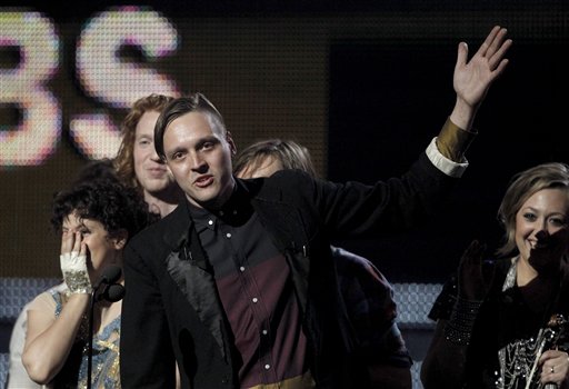 Win Butler, center, is joined by fellow band members of Arcade Fire to accept the award for album of the year at the 53rd annual Grammy Awards on Sunday, Feb. 13, 2011, in Los Angeles. (AP Photo/Matt Sayles) (AP)