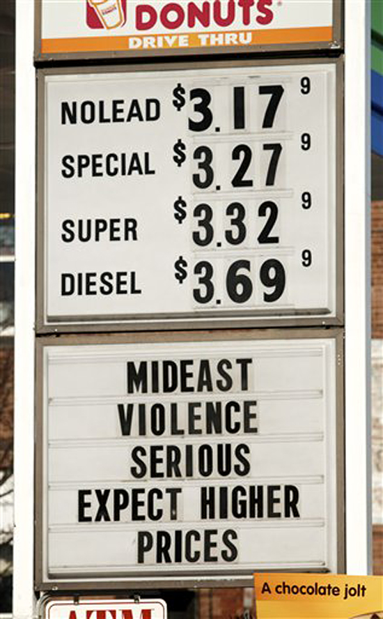 A sign advertises gas and diesel prices, plus gives an explanation to customers, at a service station in Easthampton, Mass, Wednesday, Feb. 23, 2011. Oil prices rose past $99 a barrel on Wednesday as forces loyal to Libya's Moammar Gadhafi clashed with protesters expanding their control over parts of the country. (AP Photo/ Shana Sureck) (Shana Sureck)