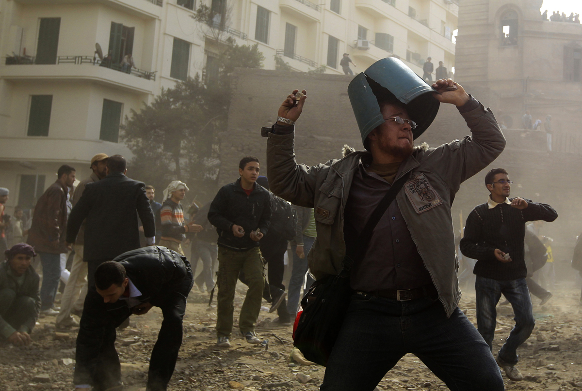 An opposition demonstrator throws a rock during rioting with pro-Mubarak supporters near Tahrir Square in Cairo February 3, 2011. Anti-government protesters and supporters of Mubarak clashed on Thursday near a central Cairo square in a re-run of overnight violence that killed six and wounded more than 800 people.  REUTERS/Goran Tomasevic (EGYPT - Tags: POLITICS CIVIL UNREST) (Â© Goran Tomasevic / Reuters)