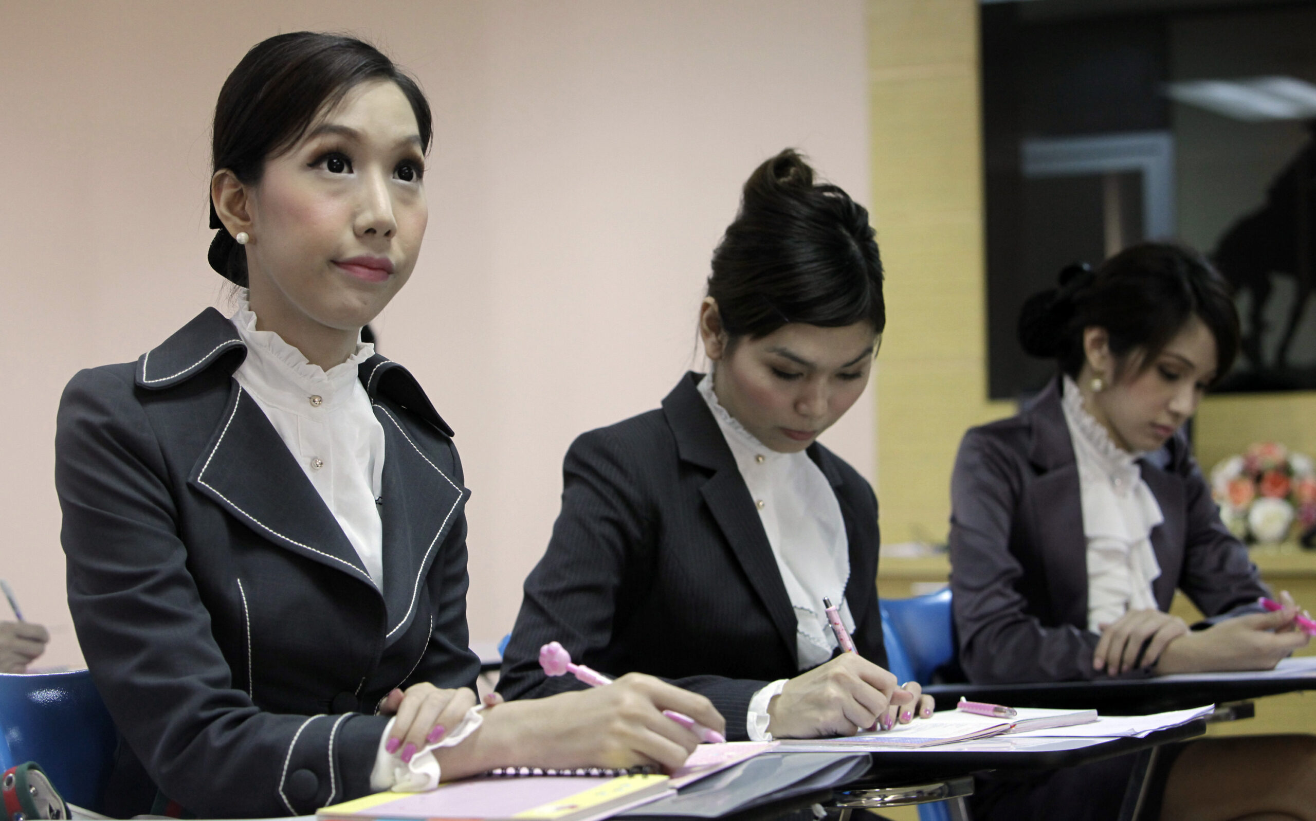TO GO WITH STORY : THAILAND TRANSVESTITE BY THANYARAT DOKSONE - In this Wednesday, Feb. 9, 2011 photo, from left to right, transvestites  Chayathisa Nakmai, Nathatai Sukkaset and Dissanai Chitpraphachin take a makeup training course, as part of the preparations for the inaugural flight of P.C. Air headquarters in Bangkok. The Thai airline is the first air company that recruited transvestites as flight attendants. (AP Photo/Sakchai Lalit) (Sakchai Lalit)