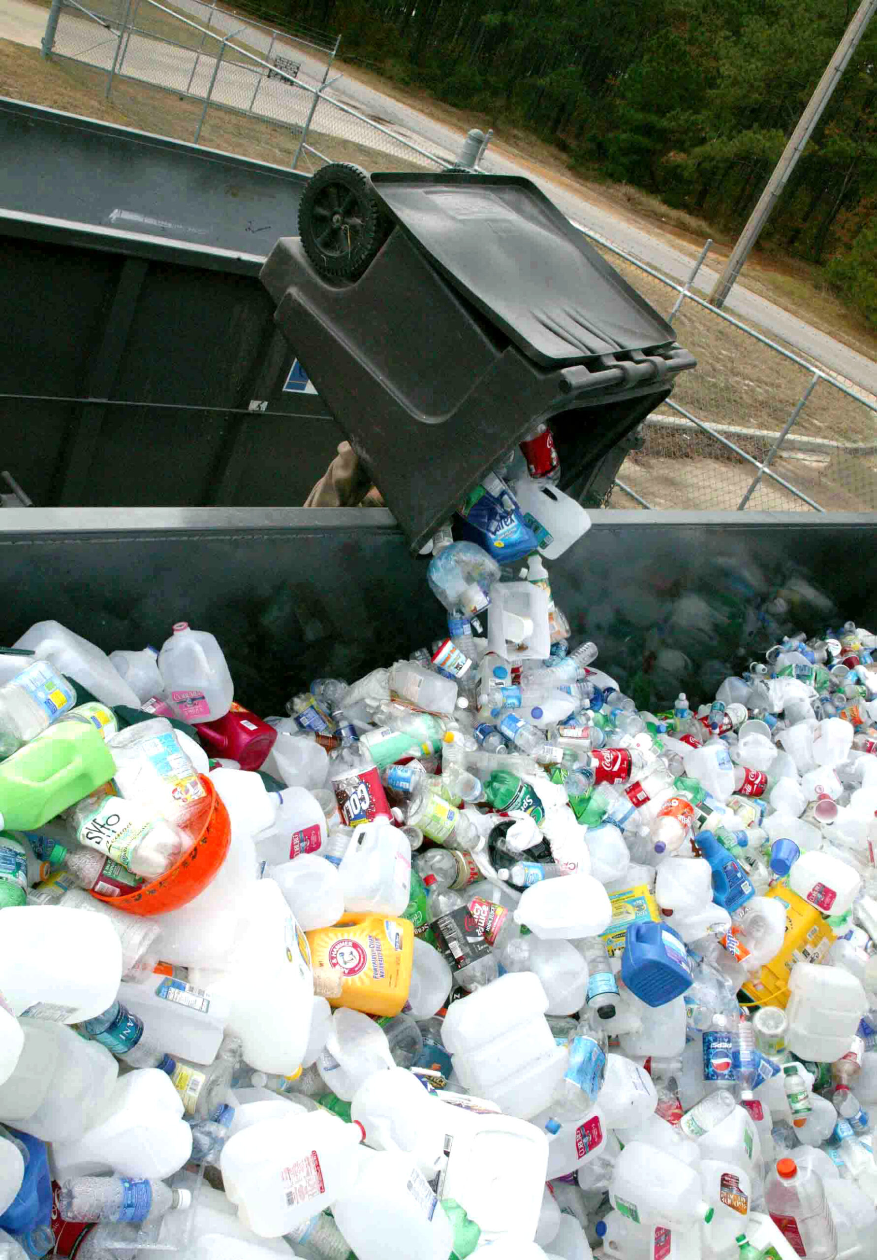 SHAW AIR FORCE BASE, S.C. -- Dana Green, Shaw's recycle center attendant, dumps a load of plastic bottles into a recycle bin Nov. 27. Shaw recycles aluminum cans, plastic and glass bottles, office paper, newspaper, magazines, cardboard, printer cartridges, shoes and metals. (U.S. Air Force photo/Staff Sgt. John Gordinier) (Staff Sgt. John Gordinier)
