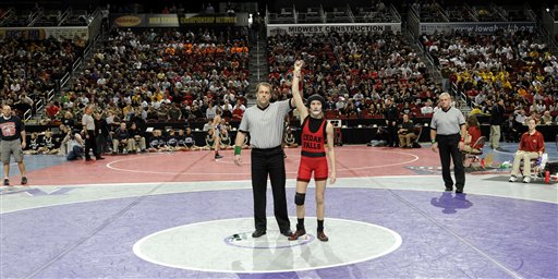 Cedar Falls' Cassy Herkelman gets her arm raised after winning by default in a Class 3A 112 pound match at the Iowa State Wrestling tournament, Thursday Feb. 17, 2011 in Des Moines, Iowa. Herkelman was one of the first girls to ever qualify for the state tournament and won by default after her opponent Joel Northrup of Linn-Mar High, refused to wrestle a girl.  (AP Photo/Steve Pope) (AP)