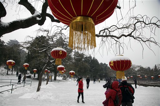 Visitors enjoy the snow scene in a park in Beijing, China, Thursday, Feb. 10, 2011.  The Chinese capital enjoyed its first snow of the winter after the longest period without snow in 60 years.  (AP Photo/Ng Han Guan) (AP)