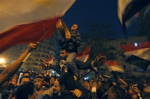 Demonstrators celebrate in Tahrir Square in Cairo, Egypt, Friday Feb. 18, 2011. Tens of thousands of flag-waving Egyptians packed into Tahrir Square for a day of prayer and celebration Friday to mark the fall Hosni Mubarak a week ago and to maintain pressure on the new military rulers to steer the country toward democratic reforms.(AP Photo/Khalil Hamra) (AP)