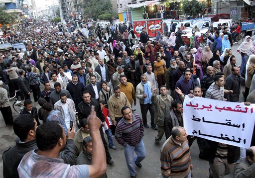 Egyptian anti-Mubarak protesters march in al Mansoura city, Egypt, Sunday, Feb. 6, 2011.  Egypt's largest opposition group, the Muslim Brotherhood, said it would begin talks Sunday with the government to try to end the country's political crisis but made clear it would insist on the immediate ouster of longtime authoritarian President Hosni Mubarak. Arabic read " People Need the Removal of the Regime". (AP Photo) (AP)