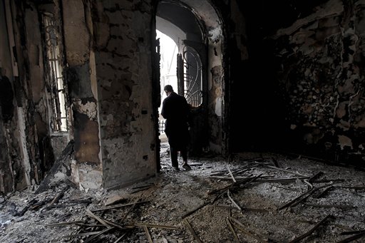 An Egyptian man surveys the fire damage at a burned and looted police station, in the Darb al Ahmar neighborhood of Cairo, Egypt, Saturday, Jan. 29, 2011. (AP Photo/Tara Todras-Whitehill) (AP)