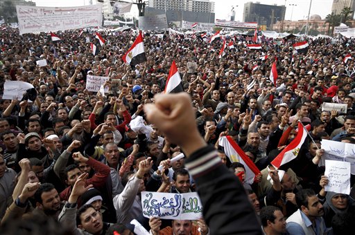 Anti-government protesters demonstrate in Tahrir Square, in Cairo, Egypt, Tuesday, Feb. 8, 2011. Protesters appear to have settled in for a long standoff, turning Tahrir Square into a makeshift village with tens of thousands coming every day, with some sleeping in tents made of blankets and plastic sheeting. The arabic on the sign reads "The rage brings the light of freedom". (AP Photo/Tara Todras-Whitehill) (AP)