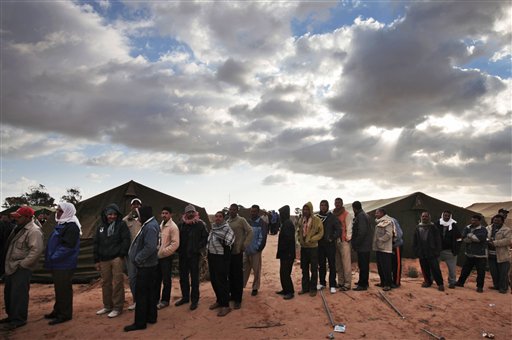 Egyptians, who used to work in Libya, and fled the unrest in the country, wait for their breakfast in a makeshift refugee camp set up by the Tunisian army, at  the Tunisia-Libyan border, in Ras Ajdir, Tunisia,  Friday, Feb. 25, 2011. (AP Photo/Lefteris Pitarakis) (AP)