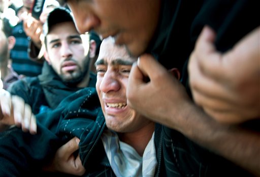 ** ADDS BYLINE ** A relative, no name available, of 20-year-old Ali Abdul Hadi Mushaima, alledgedly killed in clashes with security forces Monday, reacts during the funeral to burial Daih, Bahrain Tuesday, Feb.15, 2011. Protesters demanding sweeping political reforms from Bahrain's rulers held their ground Wednesday in an Egypt-style occupation of the capital's landmark square. (AP Photo/James Lawler Duggan) (AP)