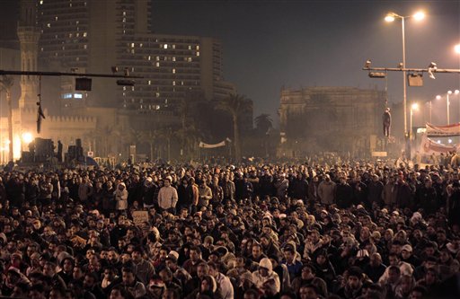 Effigies of Egyptian President Hosni Mubarak can be seen hanging from traffic lights, as Egyptian anti-government protesters gathered in Tahrir (Liberation) Square, watch U.S. President Barack Obama, not seen,  live on a TV broadcast from Washington, speaking about the situation in Egypt, early Wednesday, Feb. 2, 2011.  Egyptian President Hosni Mubarak announced  he will not run for a new term in September elections but rejected protesters' demands he step down immediately and leave the country, vowing to die on Egypt's soil, after a dramatic day in which a quarter-million Egyptians staged their biggest protest yet calling on him to go. (AP Photo/Lefteris Pitarakis) (AP)
