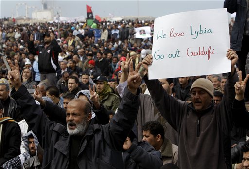 Libyan protesters shout slogans against Libyan Leader Moammar Gadhafi during a demonstration at the court square, in Benghazi, Libya, on Friday Feb. 25, 2011. Several tens of thousands held a rally in support of the Tripoli protesters in the main square of Libya's second-largest city, Benghazi, where the revolt began, about 580 miles (940 kilometers) east of the capital along the Mediterranean coast. (AP Photo/Hussein Malla) (AP)
