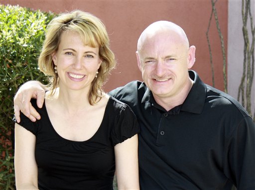 FILE - In this undated file photo provided by the office of Rep. Gabrielle Giffords, Giffords, left, is shown with her husband, NASA astronaut Mark Kelly. There are hints that astronaut Mark Kelly will take a shuttle into space in April. That would mean leaving his wounded wife, Rep. Gabrielle Giffords, to continue her rehab work without him for at least a few weeks. Scott Kelly, also an astronaut, said his brother would decide fairly soon whether to fly the space shuttle mission in April. (AP Photo/Office of Rep. Gabrielle Giffords, File) (AP)