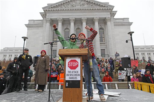 A pair of UW-Madison students fire up the crowd as sleet falls outside the state Capitol Monday, Feb. 21, 2011, in Madison, Wis. Opponents to Governor Scott Walker's bill to eliminate collective bargaining rights for many state workers are taking part in their seventh day of protesting.  (AP Photo/Jeffrey Phelps) (AP)
