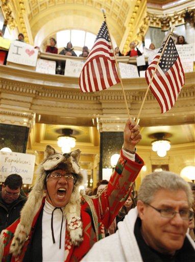 Arnold Chevalier, left, of Stoughton, Wis., shouts iinside the State Capitol Monday, Feb. 21, 2011, in Madison, Wis. Opponents to Governor Scott Walker's bill to eliminate collective bargaining rights for many state workers are taking part in their seventh day of protesting.  (AP Photo/Jeffrey Phelps) (AP)