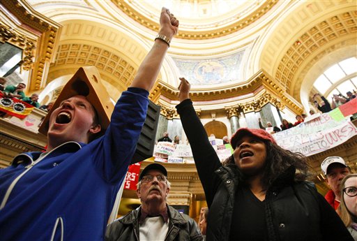 Sean Conard, left, of Green Bay, Wis., and Shyla Deacon of Milwaukee cheer during protests at the state Capitol in Madison, Wis., Saturday, Feb. 26, 2011. Protests to the governor's bill to eliminate collective bargaining rights for many state workers are in their 12th day. (AP Photo/Andy Manis) (AP)