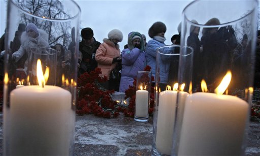 People light candles and place flowers, mourning victims of the  deadly bombing at a Moscow airport during a commemoration rally in downtown Moscow, Russia, Thursday, Jan. 27, 2011. A suicide bomber set off an explosion that ripped through Moscow's busiest airport on Monday, killing dozens of people and wounding more than a hundred. (AP Photo/Misha Japaridze) (AP)