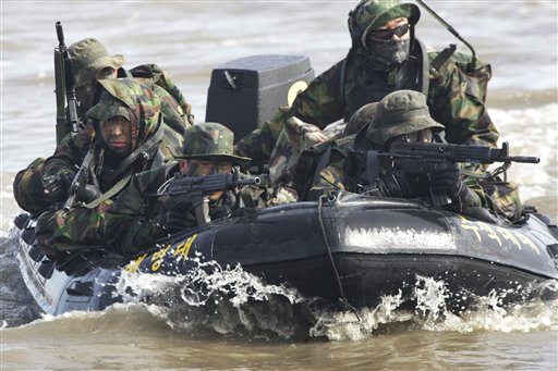 FILE - In this Feb. 25, 2011 file photo, South Korean marines on an inflatable boat aim their machine guns during a military exercise to prepare for a possible North Korea's surprise attack on the Han River in Gimpo, South Korea. North Korea's military threatened Sunday, Feb. 27, 2011 to fire at South Korea, as Seoul prepared to start annual joint drills with U.S. troops, maneuvers Pyongyang says are a rehearsal for an invasion. (AP Photo/Ahn Young-joon, File) (AP)