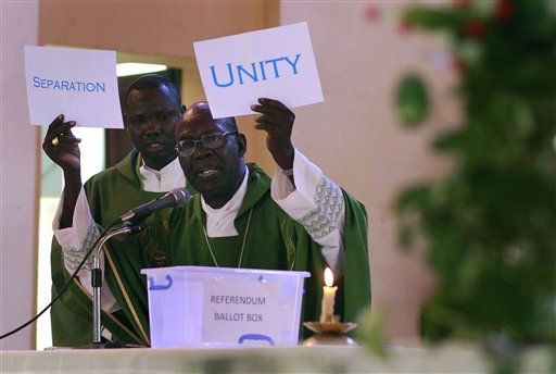 South Sudanese Catholic Archbishop Paulino Lukudu holds up mock ballots during a service attended by President Salva Kiir in  Juba, Southern Sudan, Sunday  Jan. 16, 2011. The Southern Sudan's president on Sunday offered a prayer of forgiveness for northern Sudan and the killings that occurred during a two-decade civil war, as the first results from a weeklong independence referendum showed an overwhelming vote for secession. About four million  Southern Sudanese voters cast their ballots  in a weeklong referendum on independence that is expected to split Africa's largest nation in two.(AP Photo/Jerome Delay) (AP)