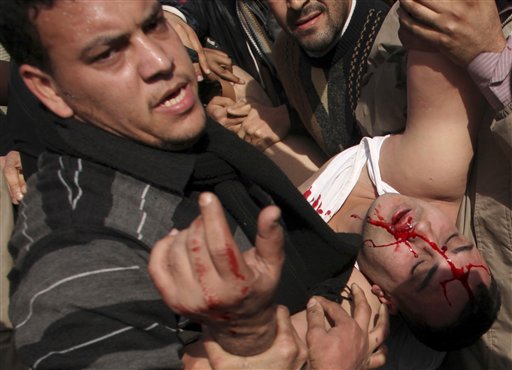 A suspected pro-government supporter,  is carried away by anti-government protestors, in Cairo's main square, Egypt, Thursday, Feb. 3, 2011. Egyptian army tanks and soldiers moved to end violence between anti-government protesters and supporters of President Hosni Mubarak in Cairo's central square on Thursday after standing by for nearly a day as the two sides battled with rocks, sticks, bottles and firebombs. (AP Photo/Tara Todras-Whitehill) (AP)